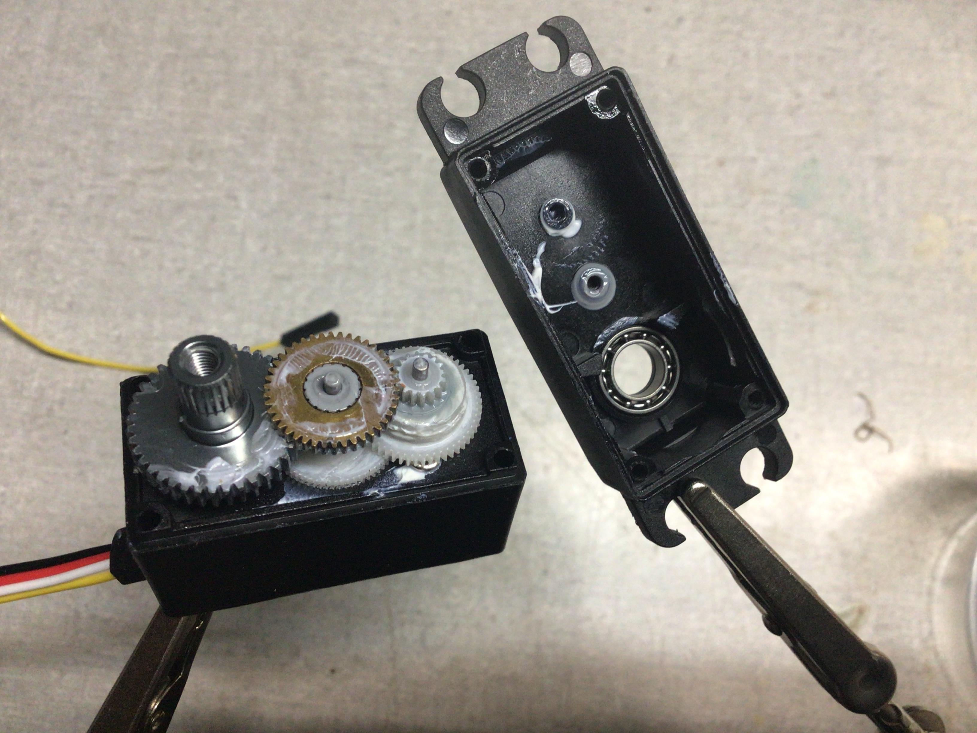 Feedback 360 motor with top removed to the side showing internal gearing and grease