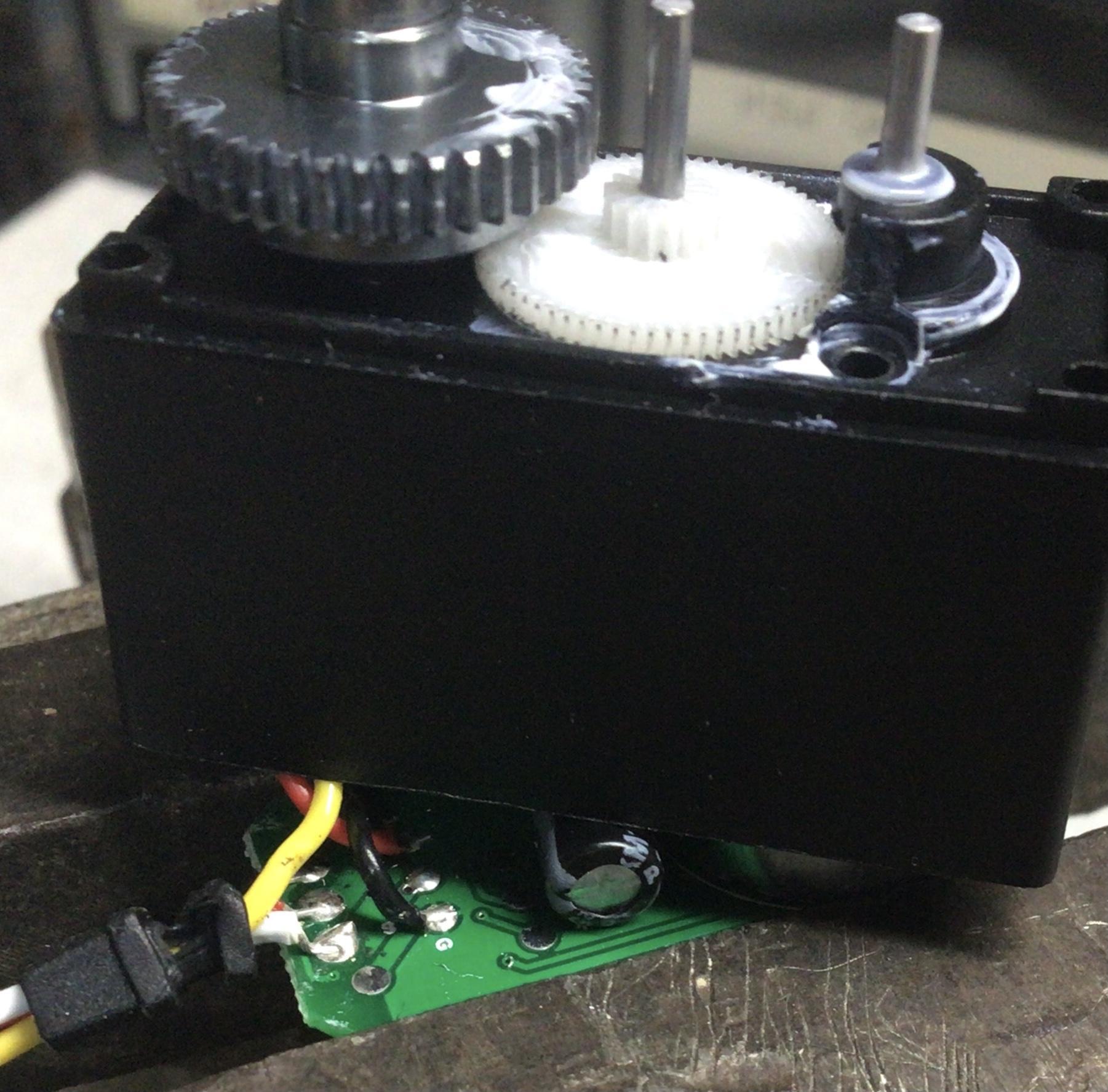 Feedback 360 motor clamped in a vise with circuit board partially removed and at an angle