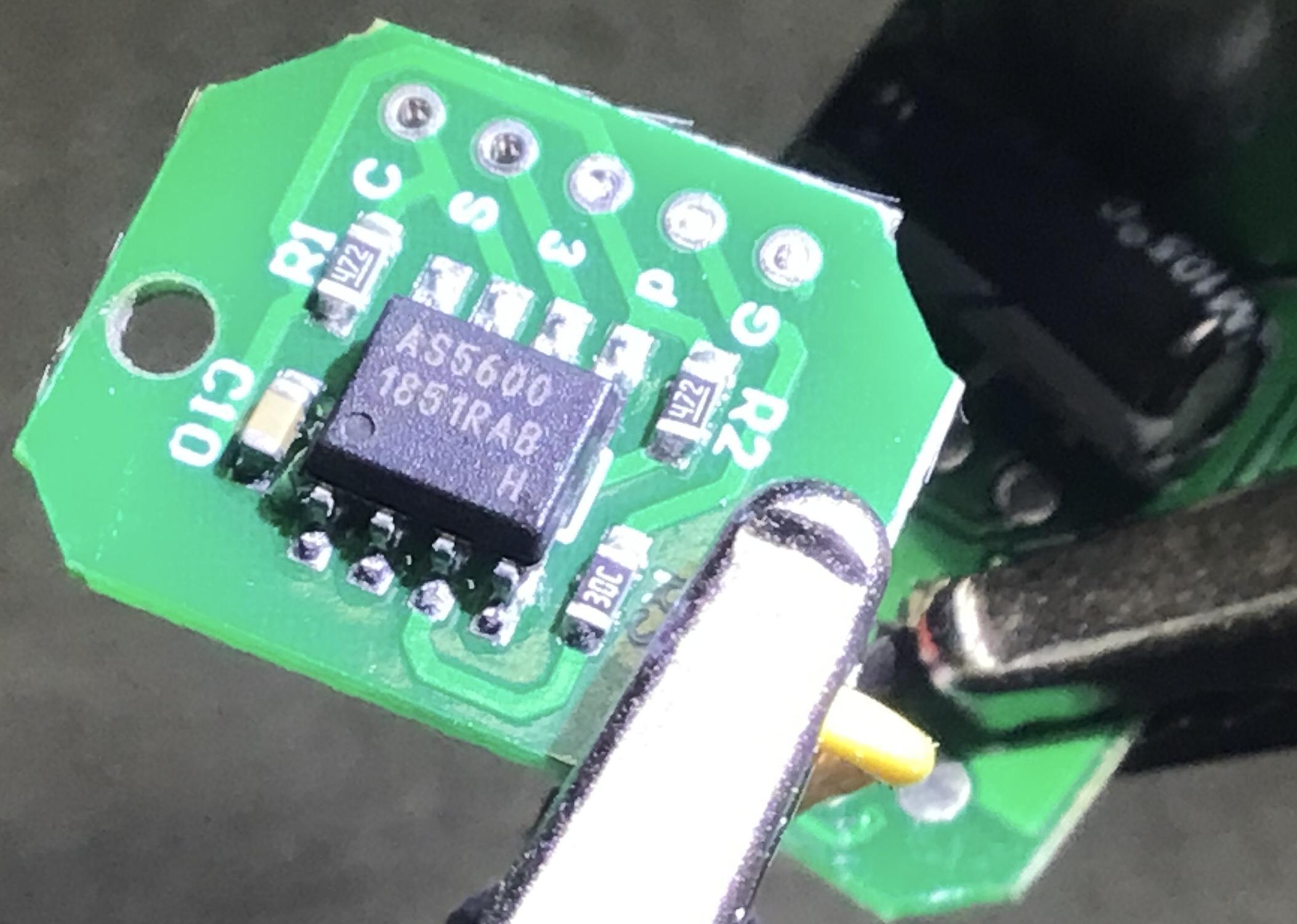 Illuminated close-up of Feedback 360 angle sensor circuit board showing IC labeled 'AS5600'